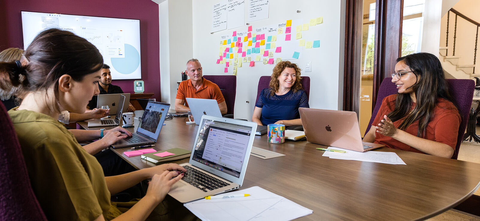 a group of TMM marketing agency employees brainstorming at a conference table