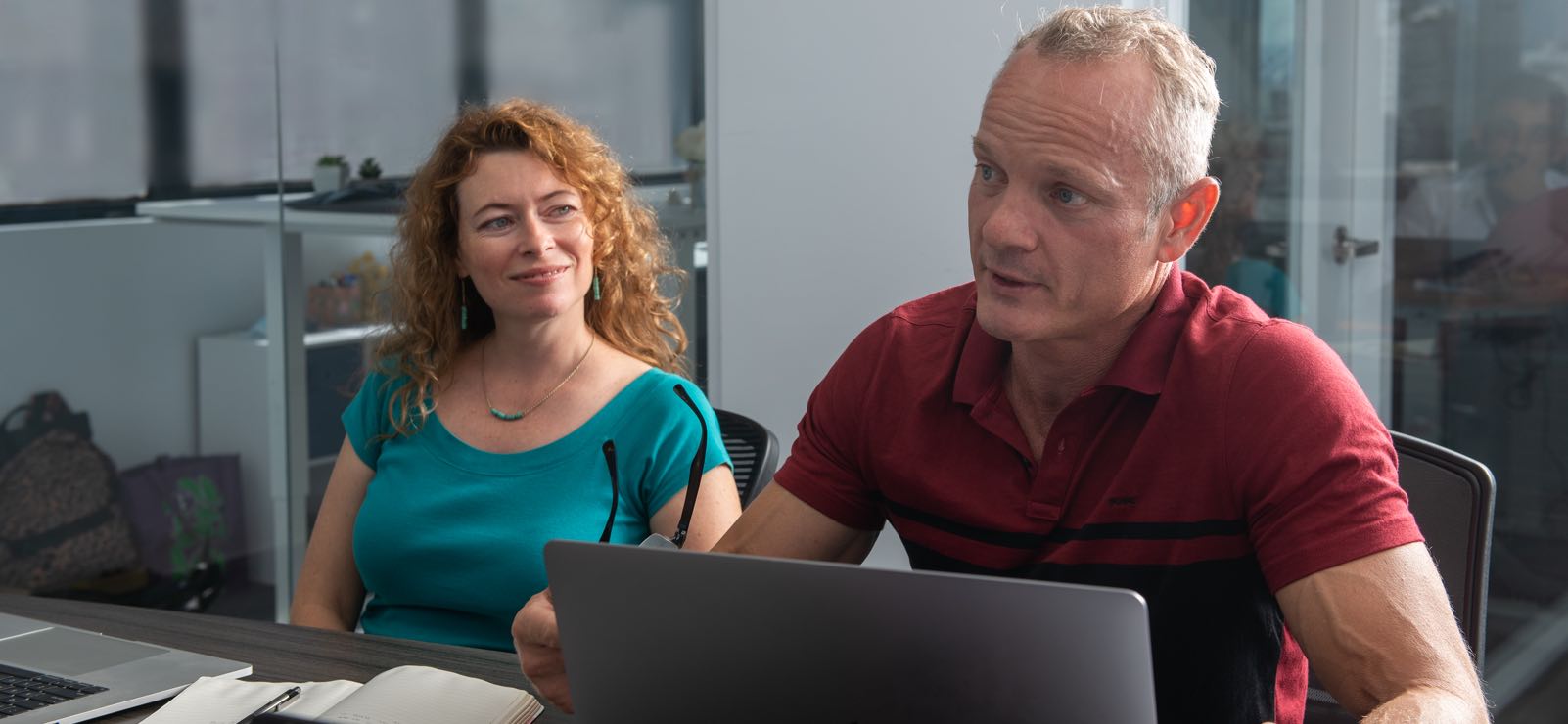 Joel Sanders and Angelika Ilina discussing marketing in the conference room
